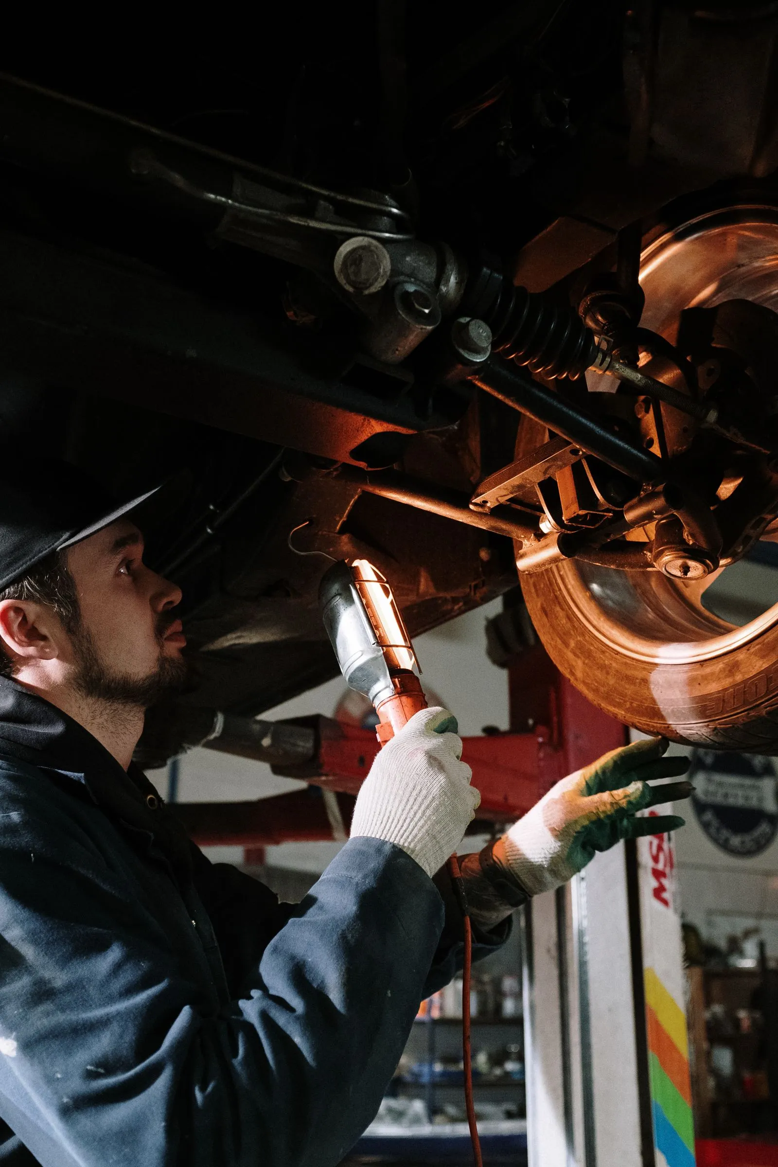 Suspension repair work in an automotive service bay